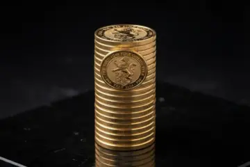 A stack of gold bullion coins highlighting the appeal of Canadian Maple Leaf coins for investors.